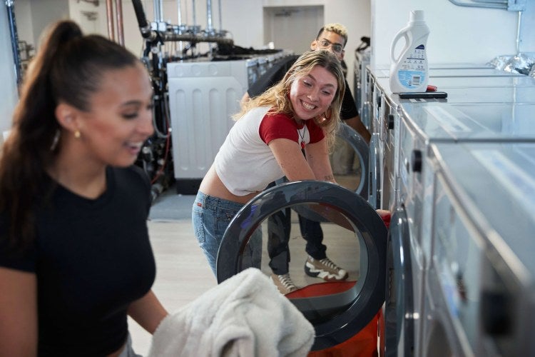 People doing laundry in FOUND Study laundry room