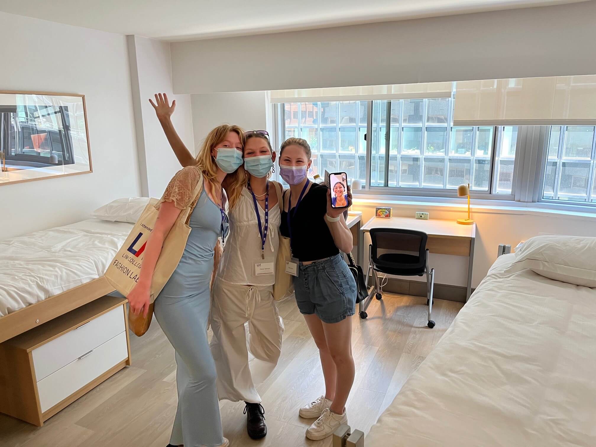 three first-year students standing in residence hall room