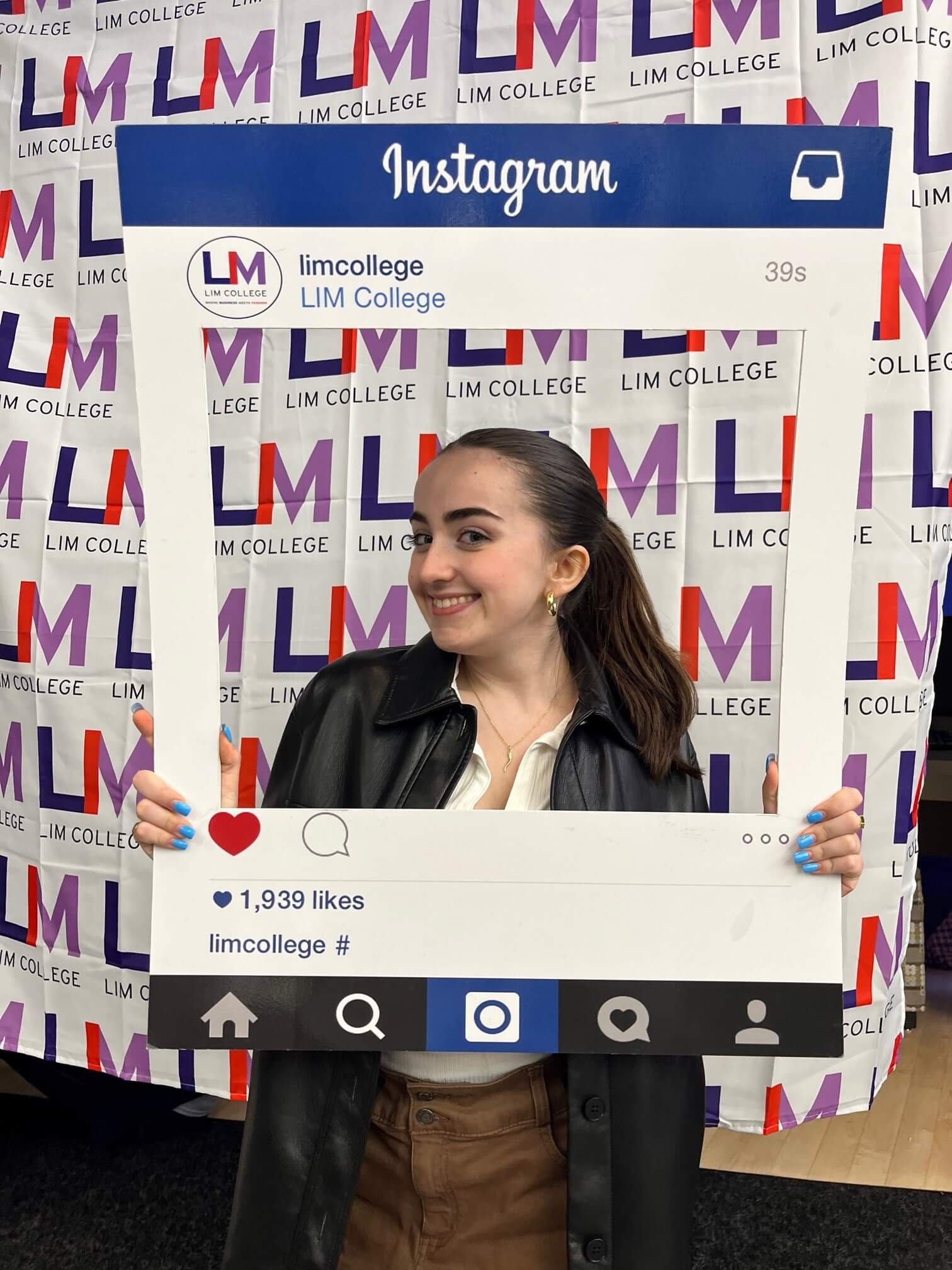 woman holding Instagram frame - LIM logo in background