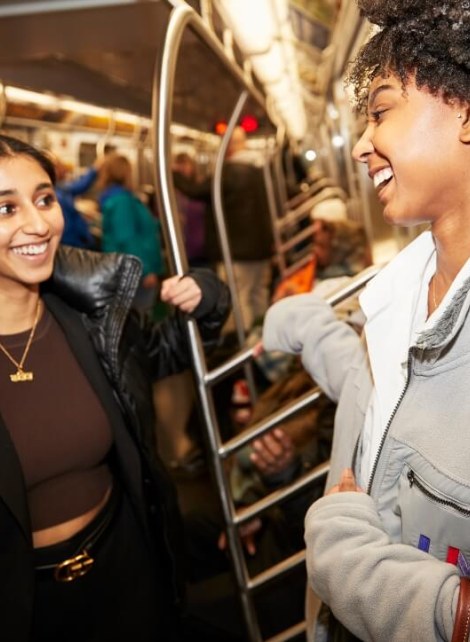 two young women riding NYC subway