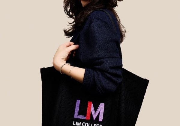 Amber Chang, dark clothes, medium shot, holding LIM tote bag