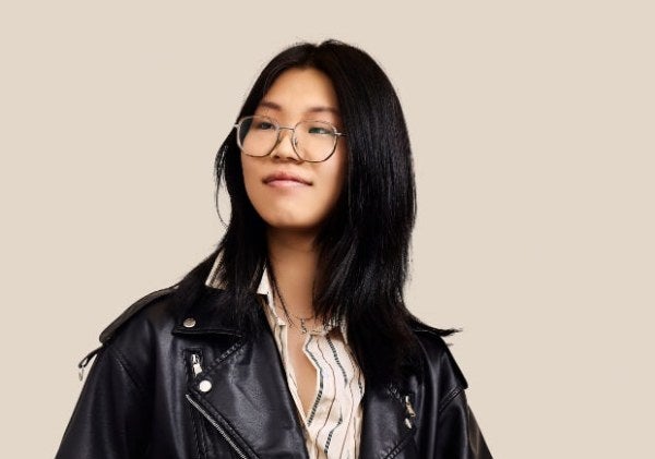 Anjing, black leather jacket, LIM laptop, medium shot