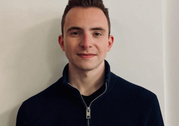 Andrew Krops, medium closeup, black-and-white half zip-up