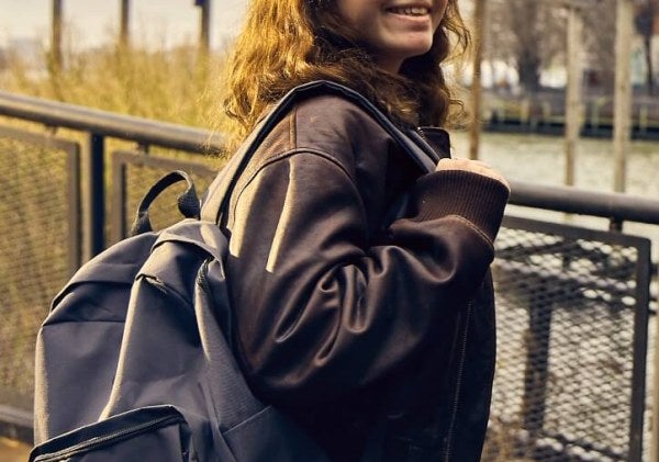 young woman, long brown hair, LIM College backpack, leather coat, South Cove Park