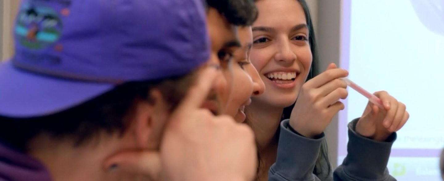 A group of students sit in discussion