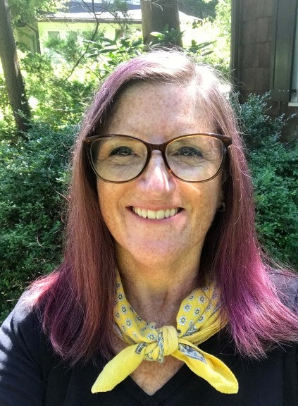 Selfie of woman with glasses and purple hair