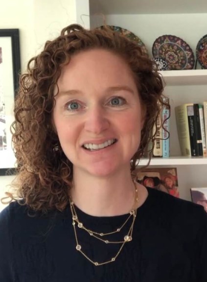 Woman standing in front of bookshelf