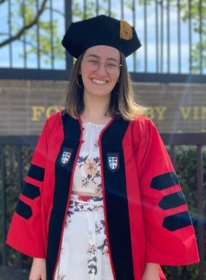 Woman with glasses in commencement regalia