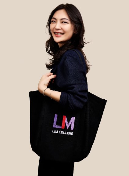 Amber Chang, dark clothes, medium shot, holding LIM tote bag