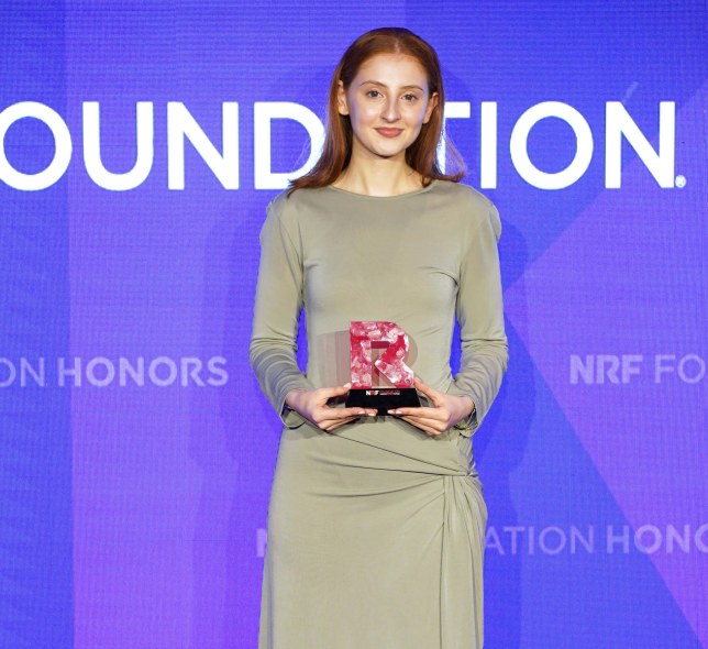 Megan Marr holding NRF Grand Prize award