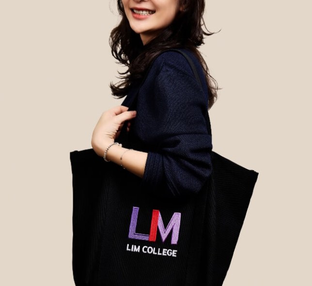 Amber Chang, dark clothes, medium shot, holding LIM tote bag