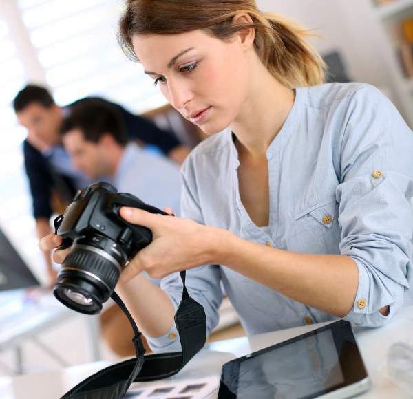 woman holds camera