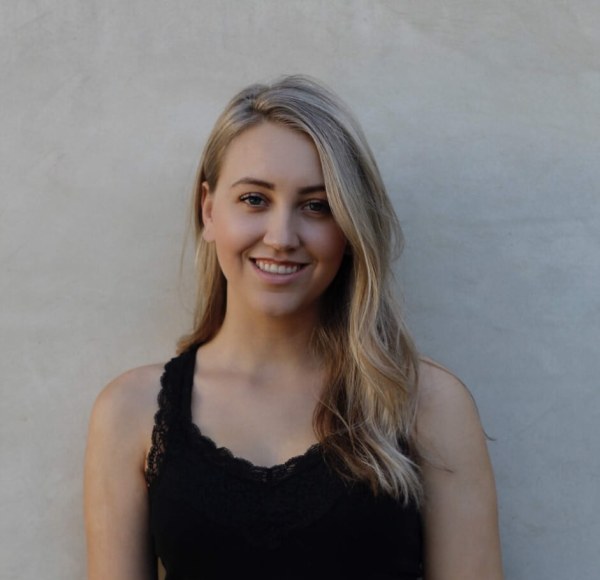 Samantha James, black shirt, plain backdrop