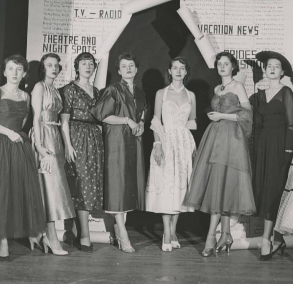 A black-and-white photo of women modeling fashions of 1962