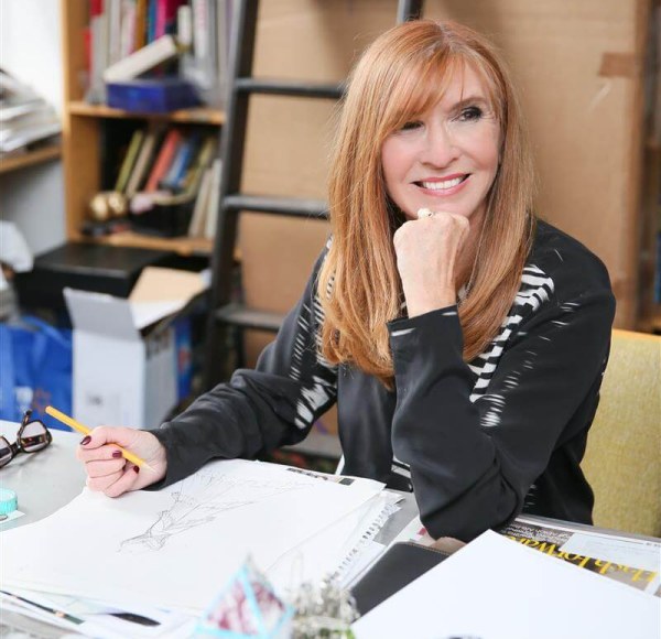 woman sitting at a desk looking off camera