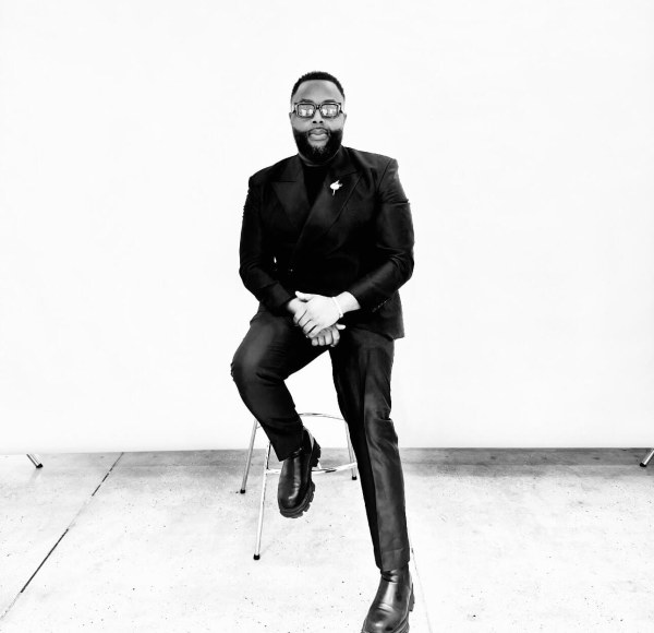 black and white photo of a man in a suit with glasses