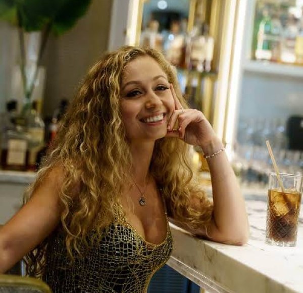 woman sitting at counter smiling