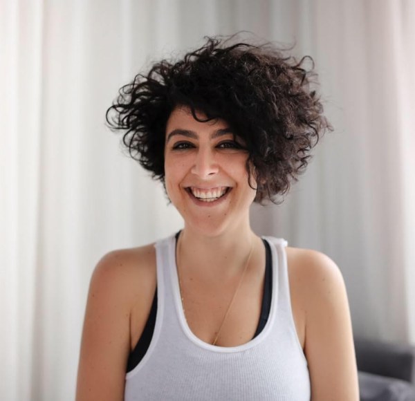 woman in tank top smiling at camera