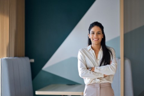 woman, long dark hair, arms folded, professional setting